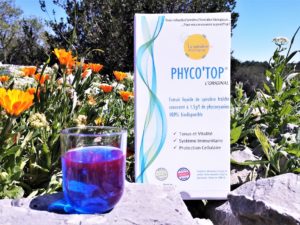 Boite Phyco'Top et verre de Phycocyanine au soleil